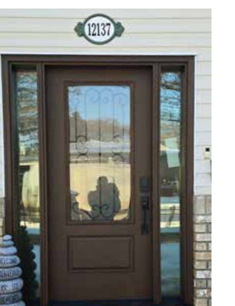 Wood-grain fiberglass entry door with decorative glass and sidelites