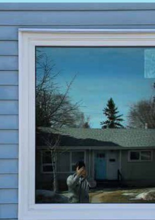 Large picture window on grey siding home