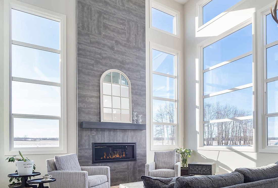 Renovated living room with stone fireplace and new windows